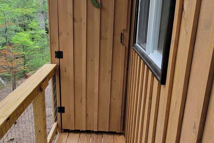Wooden ceiling and wall with a window, outdoors visible.